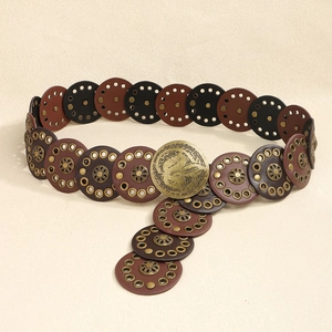 Detail of bohemian belt featuring brown and black discs with vintage brass floral rivets