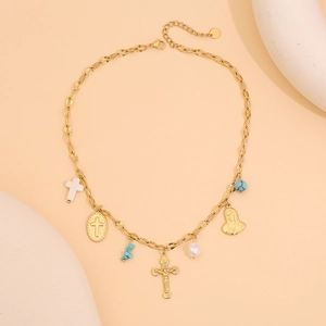 Vue détaillée de la chaîne dorée avec des breloques en croix et des pendentifs turquoise