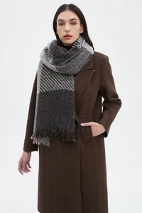 Close-up of thick plaid scarf with colorful tassels and soft woven texture details