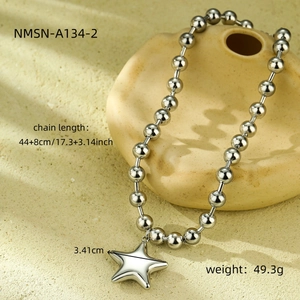 Detailed view of chunky silver bead chain necklace with polished star pendant charm