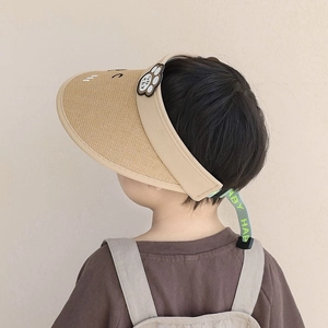 Detail of children's straw sun visor showing cute cat paw embroidery and adjustable strap