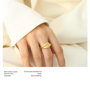 Detailed macro of minimalist 18K gold plated titanium steel double-layer ring on hand