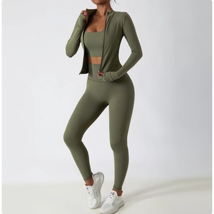 Detail of olive green yoga set including jacket with thumb holes and high waist leggings