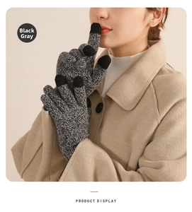 Close-up of black gray winter knit gloves with touch screen fingertips and thick warm lining