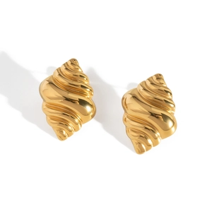 Detailed close-up of golden spiral shell earrings in polished stainless steel
