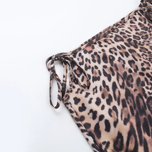 Detail of leopard print bikini fabric with adjustable side drawstring and smooth texture
