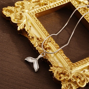 Elegant fishtail pendant necklace with stainless steel snake chain on vintage background
