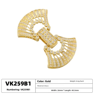 Macro view of gold brass fan-shaped jewelry clasp with pave white cubic zirconia stones
