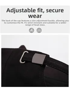 Detail of adjustable metal buckle and fabric strap on a black cotton baseball cap