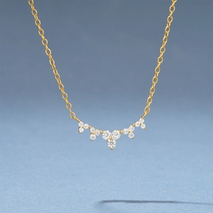 Macro view of gold S925 sterling silver necklace with sparkling cubic zirconia moon pendant