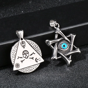 Macro view of gothic steel pendants featuring all-seeing eye and blue evil eye charms