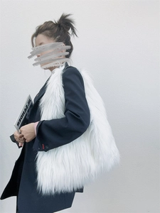 Detail of white shaggy faux fur tote bag showing plush texture and large capacity