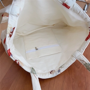 Internal view of a quilted tote bag featuring a white lining and secure zippered pocket