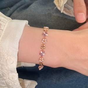 Elegant rose gold flower bracelet with zircon stones and pearls on a female wrist
