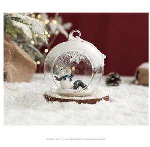 Detailed view of snowman inside a glass Christmas ornament on a rustic wooden base