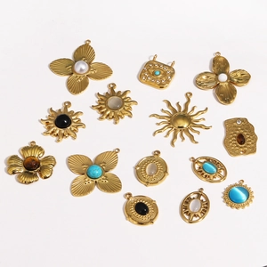 Detailed flat lay of vintage gold titanium steel charms with opal and gemstones