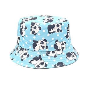 Detail of baby sun hat showing light blue polka dots and cute panda prints with fine stitching