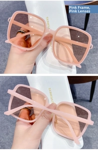 Close-up of stylish pink square oversized sunglasses with matching pink lenses and case