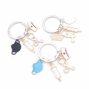Detail of medical charms including mask, stethoscope and syringe on keychain pendants