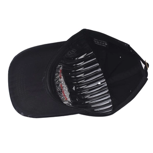 Detail view of cotton baseball cap interior with wash care label and stitching