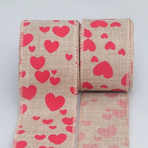 Detail of red heart printed burlap ribbon with wired edges for DIY gift wrapping
