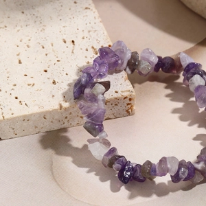 Macro shot of bohemian elastic bracelet featuring natural purple amethyst stone chips
