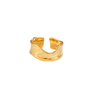 Detailed view of gold plated open ring featuring irregular wave edges and hammered texture