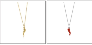 Detail view of gold horn and red enamel pepper pendants on delicate necklaces