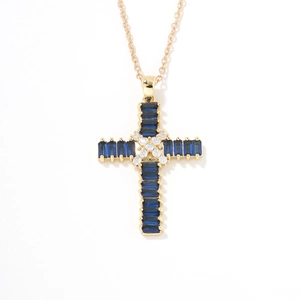 Detailed close-up of a golden cross pendant featuring rectangular blue and white crystals