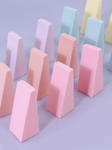 Macro view of macaron-colored wedge makeup sponges showing high density texture and detail