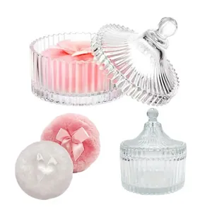 Detail of vintage ribbed glass powder jars with pink and white plush bow puffs