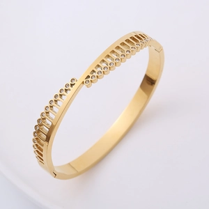 Detailed view of gold geometric triangle bracelet with sparkling zircon stones inlay