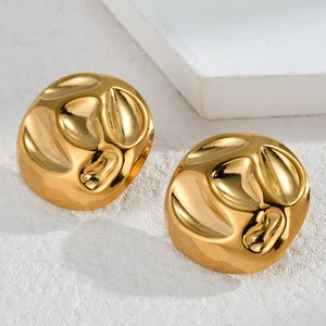 Detail of gold 18K plated earrings featuring unique irregular convex textures and glossy finish