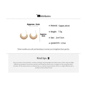 Detail showing 2cm golden crescent moon earrings with cubic zirconia and silver needles