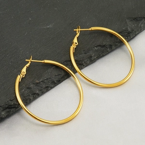 Classic 18K gold plated stainless steel hoop earrings on dark slate background