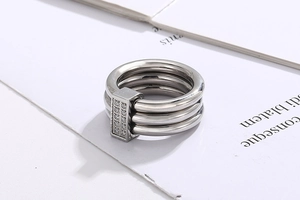 Detail of three-layer stainless steel ring with rectangular pavé set zircon elements