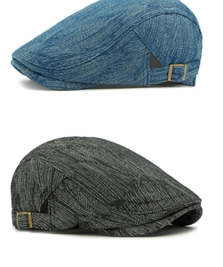 Detail view of denim beret hats showing vintage texture and adjustable bronze metal buckles