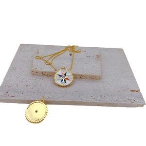 Gold plated compass star pendant necklace with colorful enamel and inset gemstone
