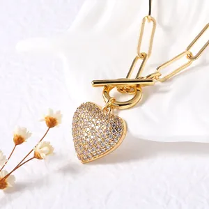 Gold heart pendant necklace with clear cubic zirconia on a paperclip chain with toggle clasp