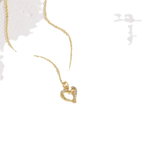 Elegant gold heart pendant necklace featuring sparkling white zircons and a minimalist chain