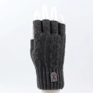 Close-up of dark grey knitted fingerless glove featuring elastic cuffs and deer logo patch