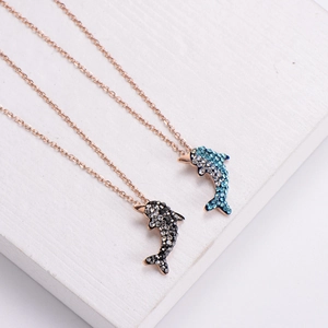 Blue dolphin tail pendants in dark and light blue crystal with gold chain necklace