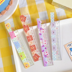 Detailed view of four 15cm cute cartoon rulers with colorful patterns on a white tray