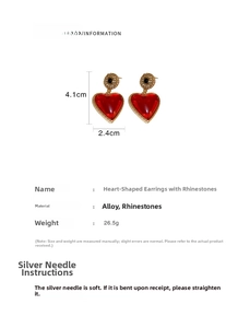 Detail view of red heart earrings with crystals and vintage pearls on white background