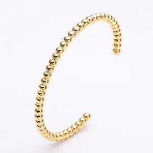 Elegant gold beaded C-shaped cuff bracelet made of polished stainless steel for women