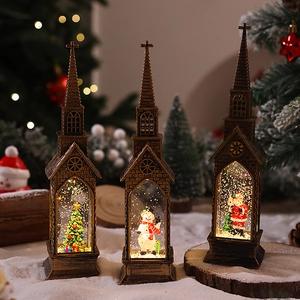 Close-up of three bronze lantern snow globes with Santa, snowman and Christmas tree scene