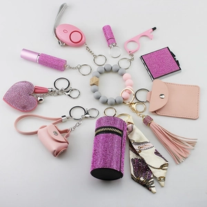 Detail view of pink self-defense keychain set with alarm and silicone bead bracelet