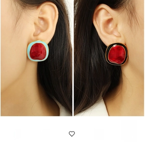 Close-up of geometric enamel stud earrings featuring bold irregular pebble design