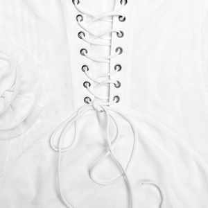 Detail of white mesh dress featuring corset-style lace-up design and 3D floral applique