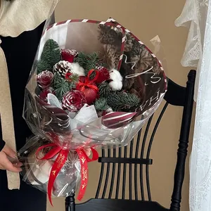Christmas apple bouquet kit with red roses, pine cones, and festive gold-lettered ribbon